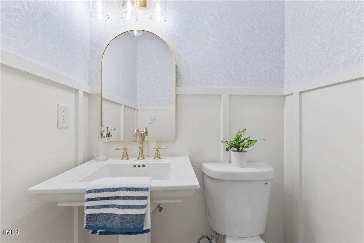 217 Brandon Court Raleigh, NC 27609 - Photo 13 of 30 a bathroom with a sink a toilet and a mirror