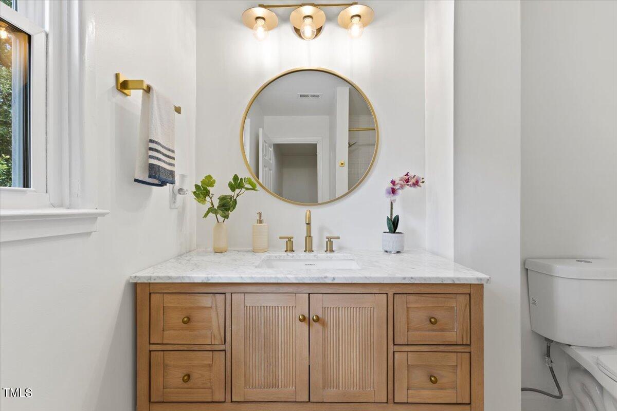 217 Brandon Court Raleigh, NC 27609 - Photo 21 of 30 a bathroom with a sink and a mirror
