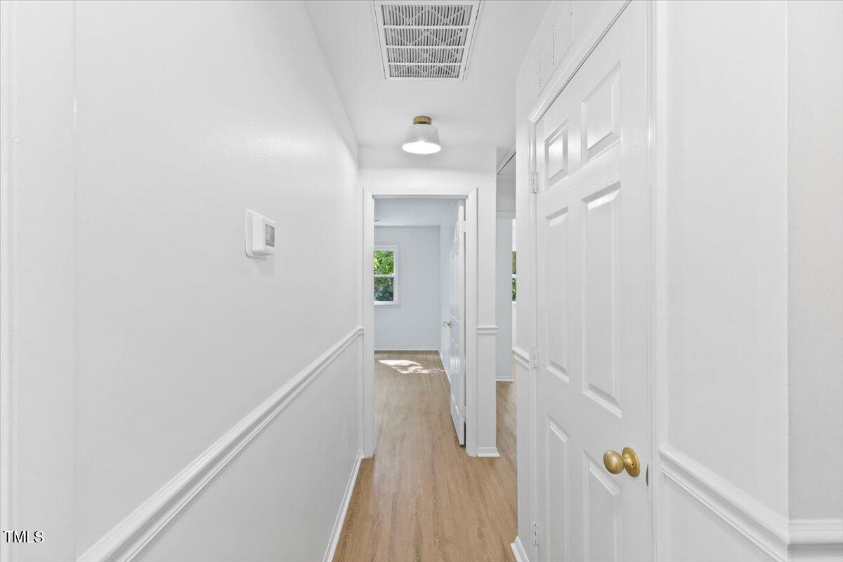 217 Brandon Court Raleigh, NC 27609 - Photo 23 of 30 a view of a hallway with a white walls