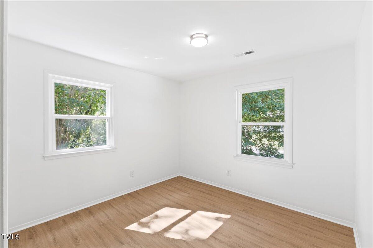 217 Brandon Court Raleigh, NC 27609 - Photo 25 of 30 an empty room with wooden floor and windows