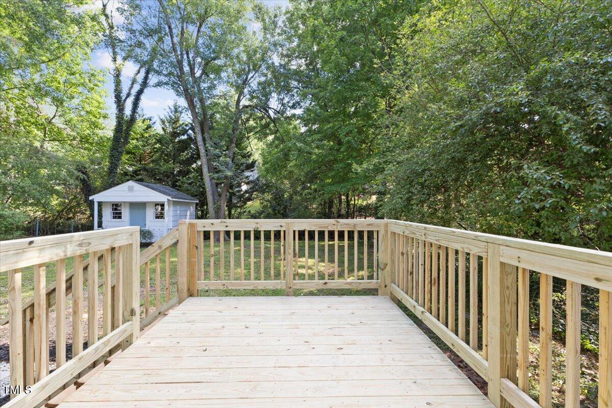 217 Brandon Court Raleigh, NC 27609 - Photo 29 of 30 a view of a wooden deck and a yard with wooden fence