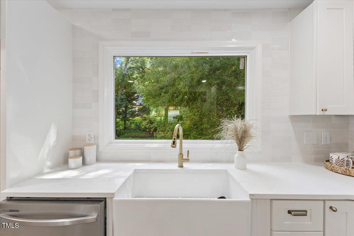 217 Brandon Court Raleigh, NC 27609 - Photo 10 of 30 a kitchen with a sink and large window