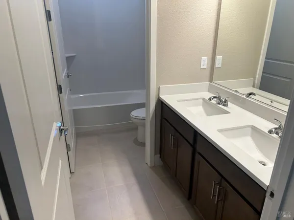 a white toilet sitting next to a bath tub