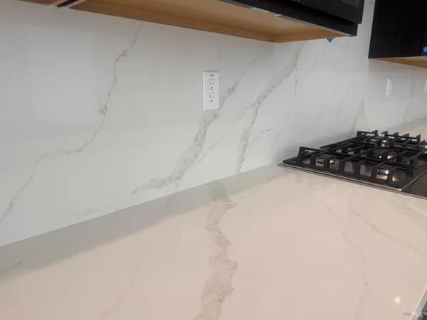 a living room with wooden floor and large window