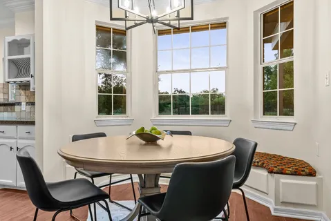 a dining room with furniture and window