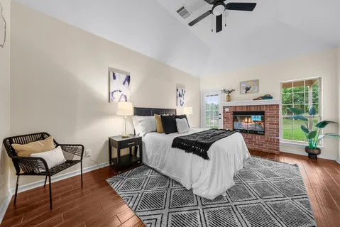 a bedroom with furniture and a fireplace