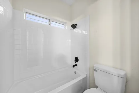 a bathroom with a bathtub and a toilet