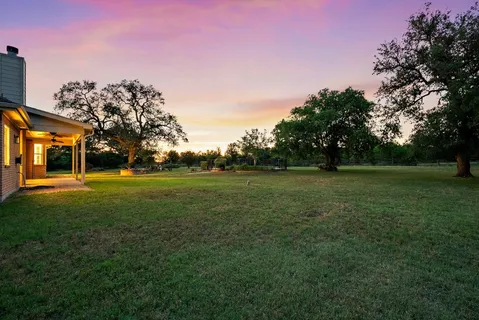 a view of building with green field
