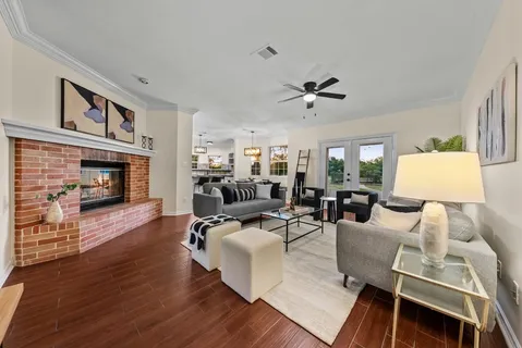 a living room with furniture a fireplace and a table