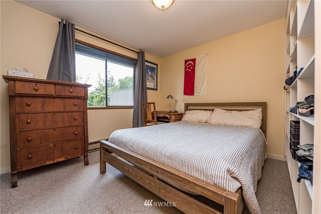 283 Williamson Road Sequim, WA 98382 - Photo 14 of 38 a bedroom with a bed and a window