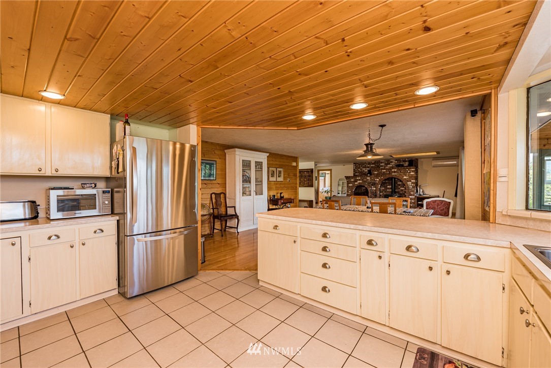 283 Williamson Road Sequim, WA 98382 - Photo 7 of 38 a kitchen with granite countertop white cabinets and stainless steel appliances