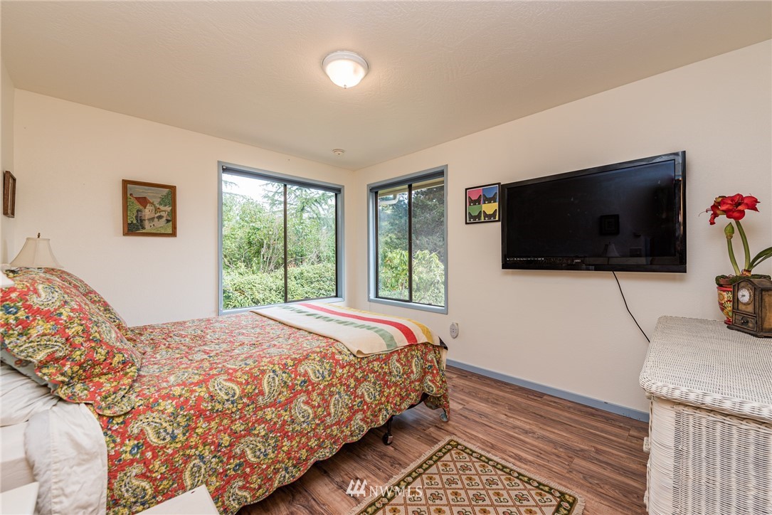 283 Williamson Road Sequim, WA 98382 - Photo 10 of 38 a bedroom with a bed and a flat screen tv