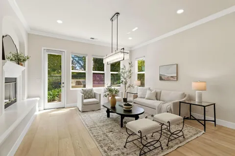 a living room with furniture large window and flat screen tv