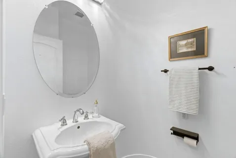 a bathroom with a sink a mirror and a toilet