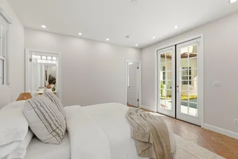 a bedroom with a large bed and a large window