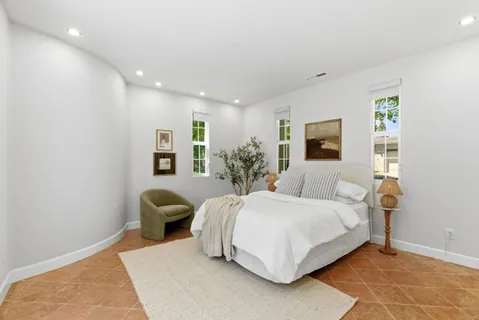 a spacious bedroom with a bed and a couch