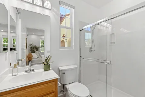 a bathroom with a sink toilet and shower