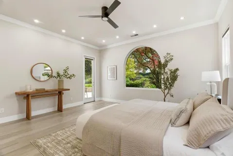a bedroom with a large bed and a large window