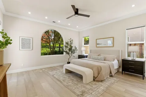 a spacious bedroom with a large bed and a window