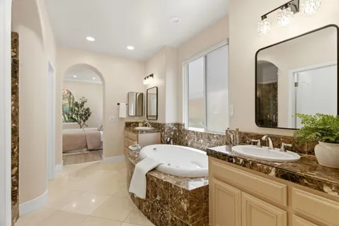 a spacious bathroom with a double vanity sink and a mirror