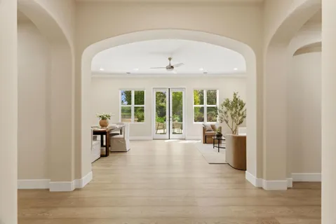 a view of a livingroom with wooden floor and furniture