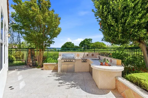 a view of a patio with furniture and a backyard