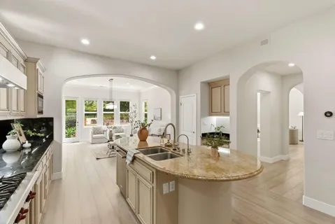 a kitchen with granite countertop a sink and a stove top oven