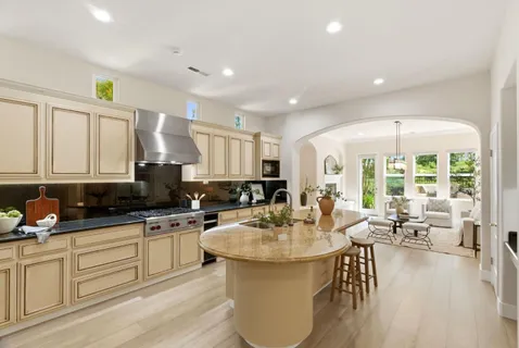 a kitchen with sink stove and cabinets