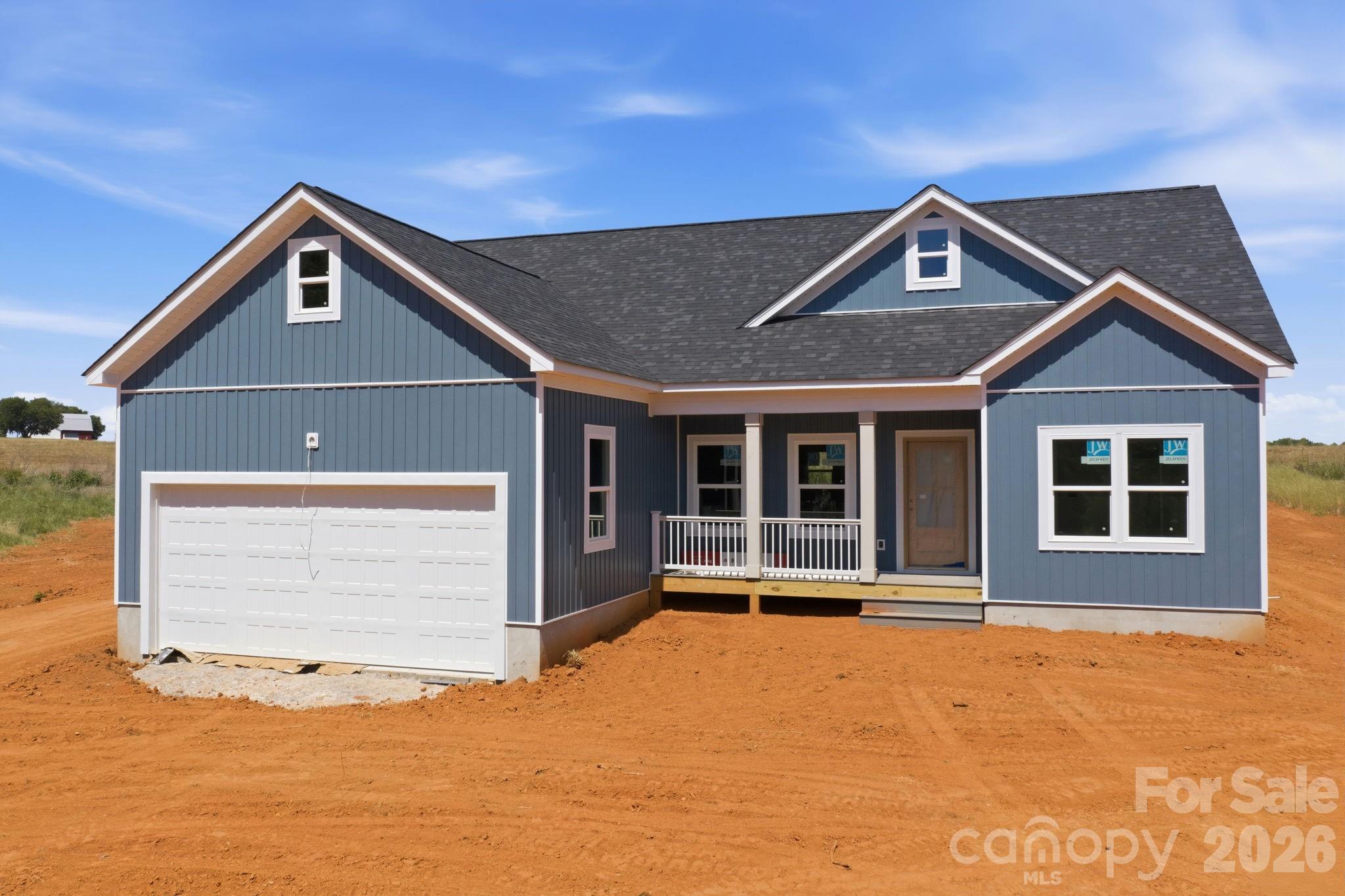 1720 Jennings Road Olin, NC 28660 - Photo 2 of 15 a front view of a house with a yard and garage