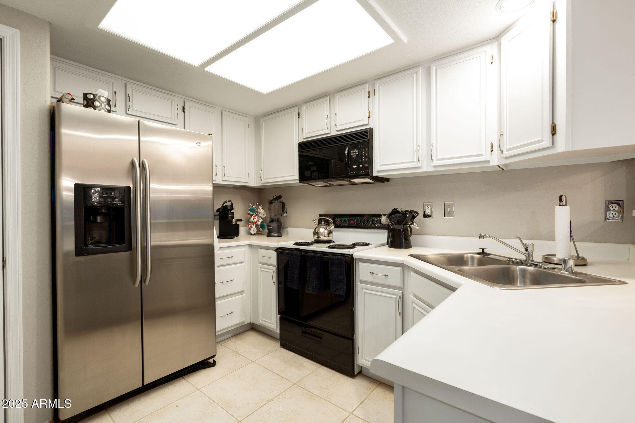 10410 North Cave Creek Road, Unit 2035 Phoenix, AZ 85020 - Photo 5 of 20 a kitchen with a sink stainless steel appliances and white cabinets