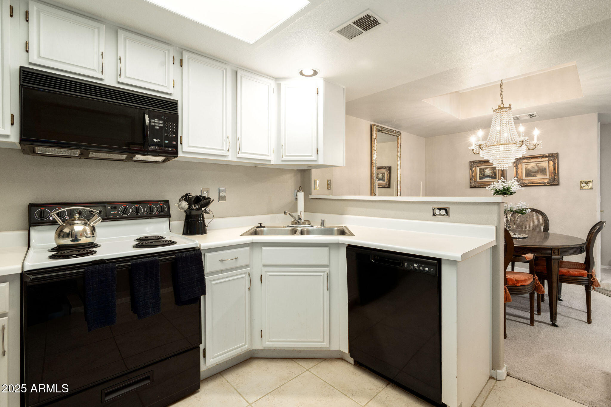 10410 North Cave Creek Road, Unit 2035 Phoenix, AZ 85020 - Photo 6 of 20 a kitchen with a sink stove and microwave
