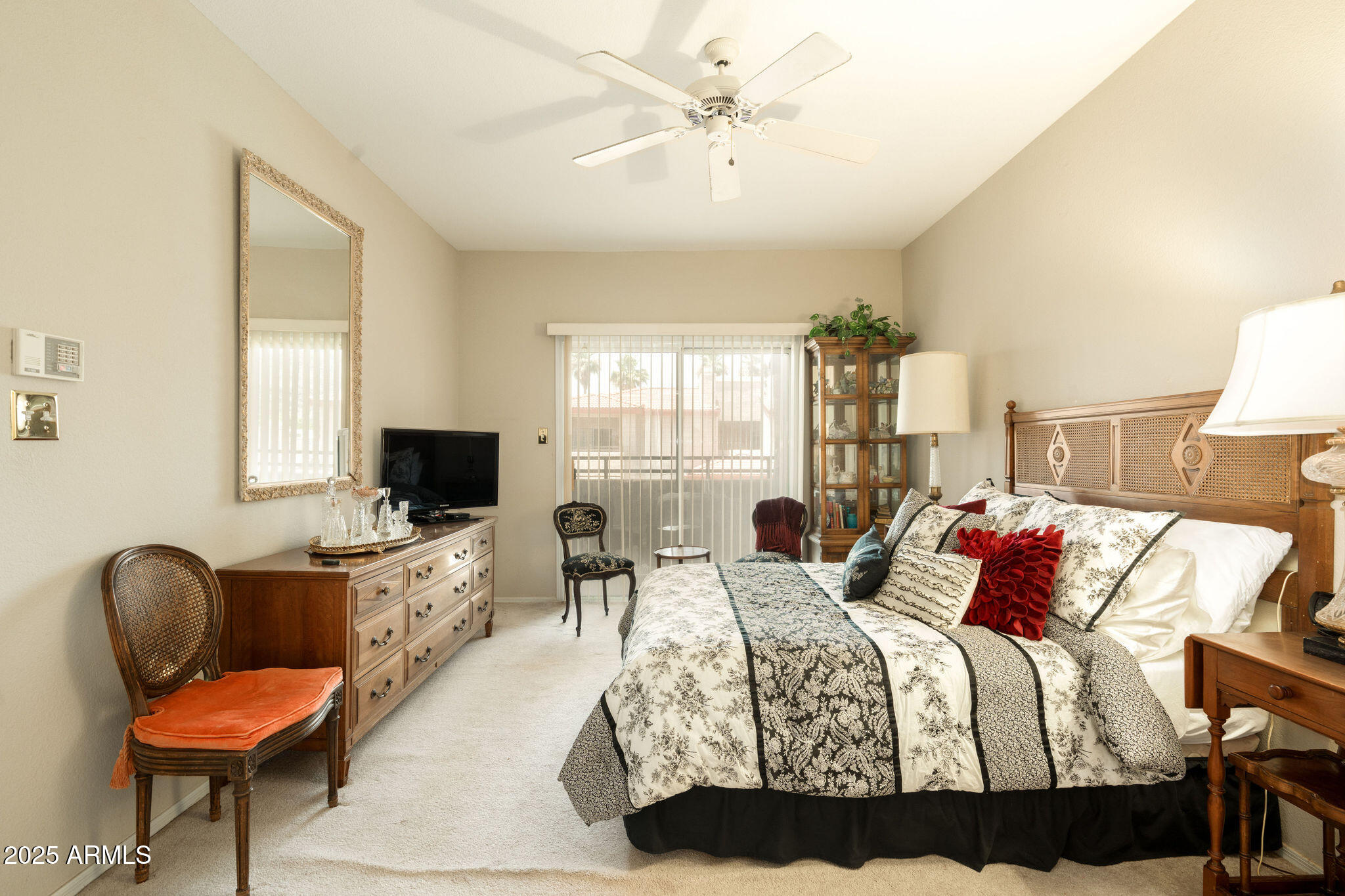 10410 North Cave Creek Road, Unit 2035 Phoenix, AZ 85020 - Photo 10 of 20 a bedroom with a bed a chair and a flat screen tv
