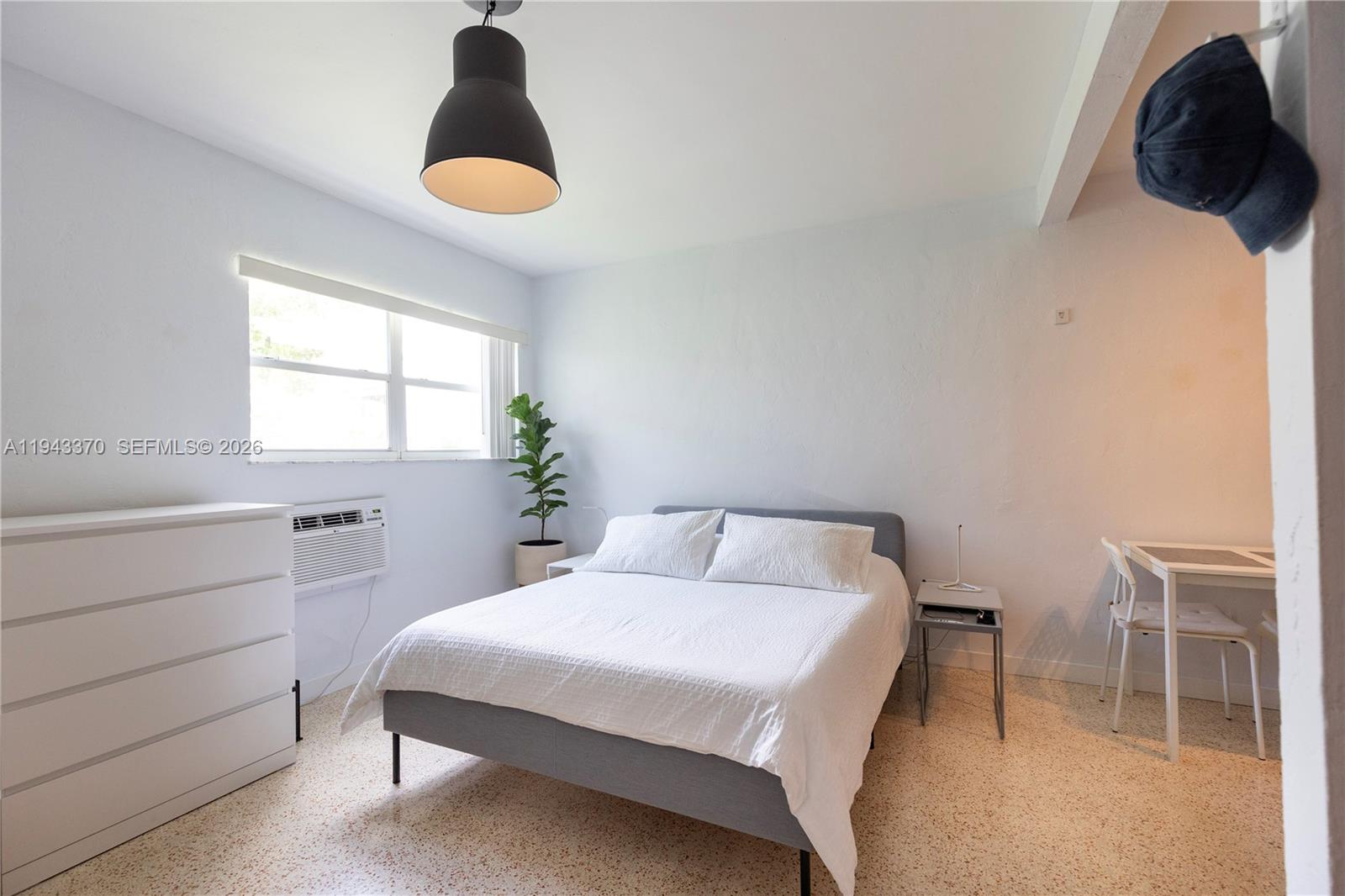 2825 Southwest 3rd Avenue, Unit 1 Miami, FL 33129 - Photo 2 of 11 a bedroom with a bed and a window