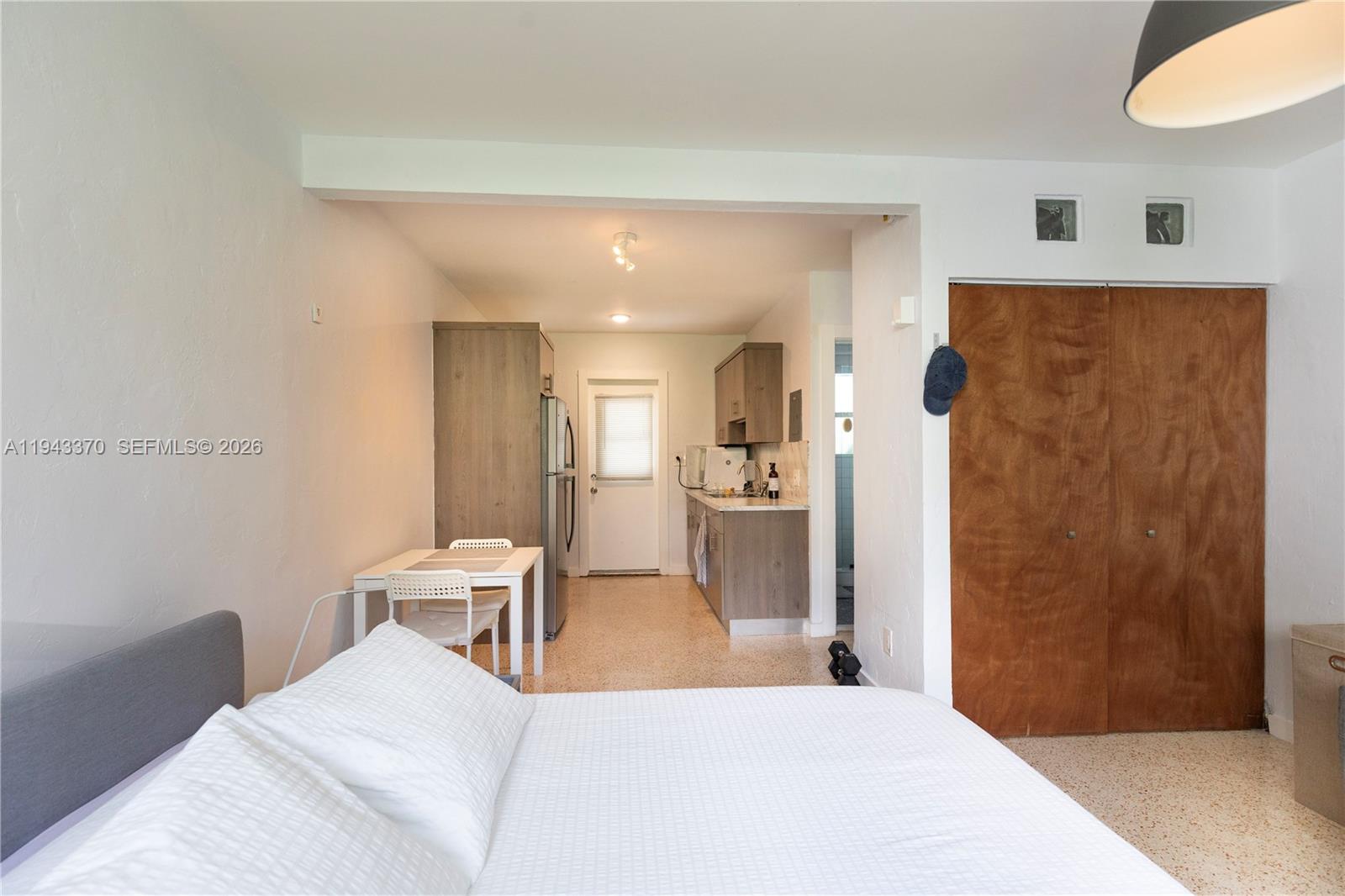 2825 Southwest 3rd Avenue, Unit 1 Miami, FL 33129 - Photo 3 of 11 a bedroom with a bed and a table in it