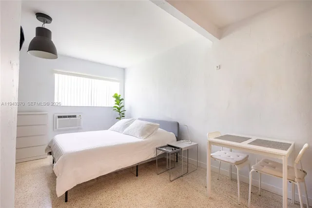 a bedroom with a bed and a table