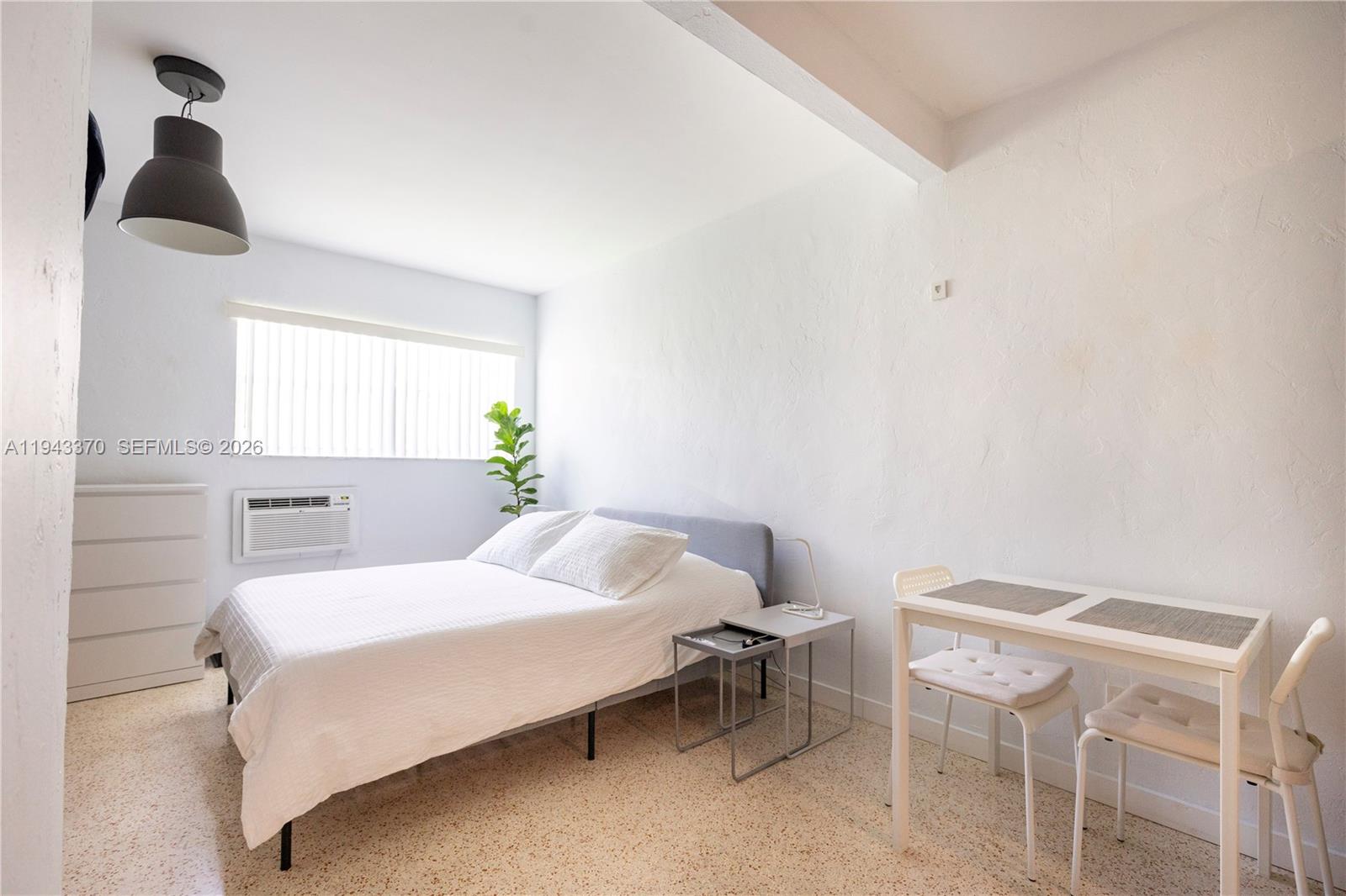 2825 Southwest 3rd Avenue, Unit 1 Miami, FL 33129 - Photo 4 of 11 a bedroom with a bed and a table