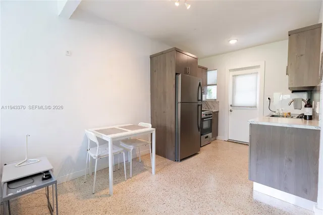 a kitchen with a refrigerator and a sink