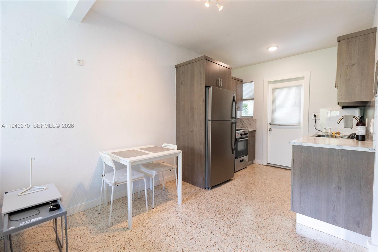 2825 Southwest 3rd Avenue, Unit 1 Miami, FL 33129 - Photo 5 of 11 a kitchen with a refrigerator and a sink