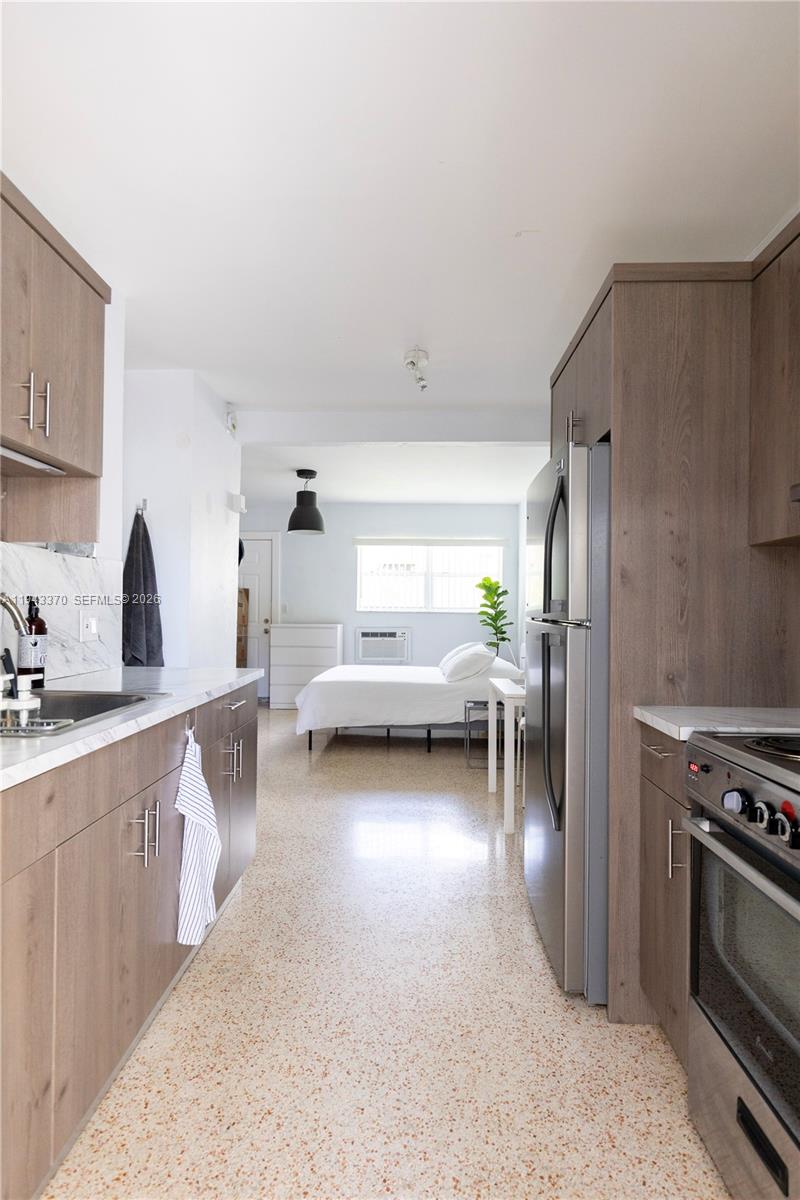 2825 Southwest 3rd Avenue, Unit 1 Miami, FL 33129 - Photo 6 of 11 a kitchen with furniture a refrigerator and a sink