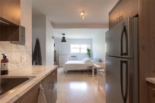 a kitchen with stainless steel appliances granite countertop a refrigerator and a sink