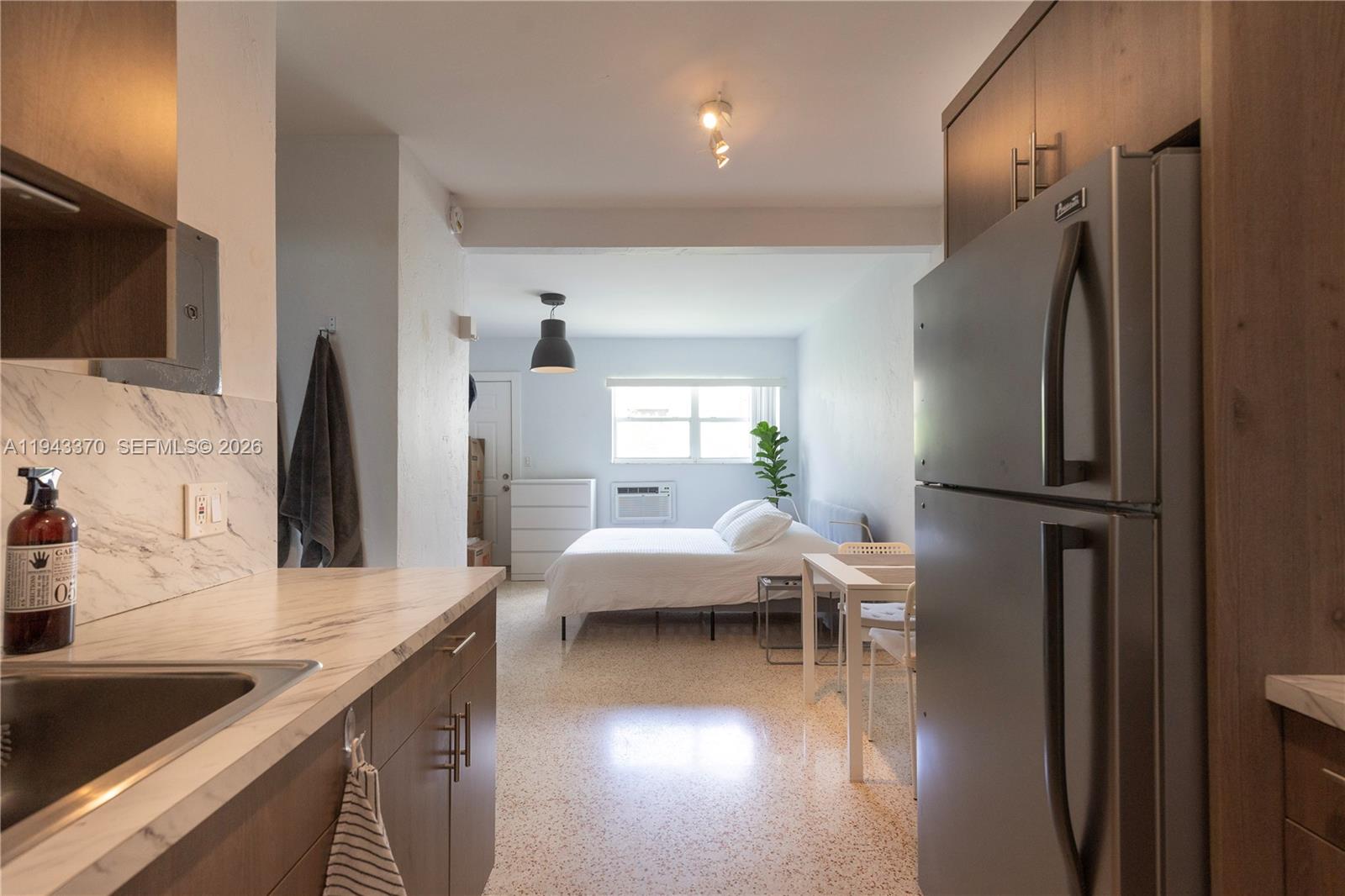 2825 Southwest 3rd Avenue, Unit 1 Miami, FL 33129 - Photo 7 of 11 a kitchen with stainless steel appliances granite countertop a refrigerator and a sink