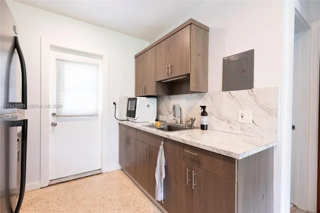 a kitchen with a sink cabinets and a window