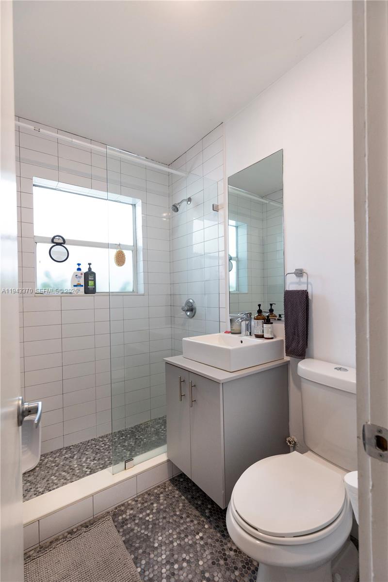 2825 Southwest 3rd Avenue, Unit 1 Miami, FL 33129 - Photo 10 of 11 a bathroom with a sink a toilet and shower
