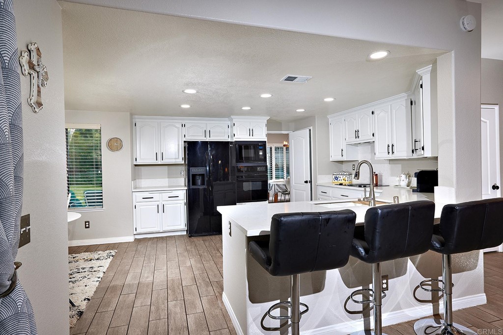 3518 Sarah Ann Drive Fallbrook, CA 92028 - Photo 11 of 49 a large kitchen with cabinets table and chairs