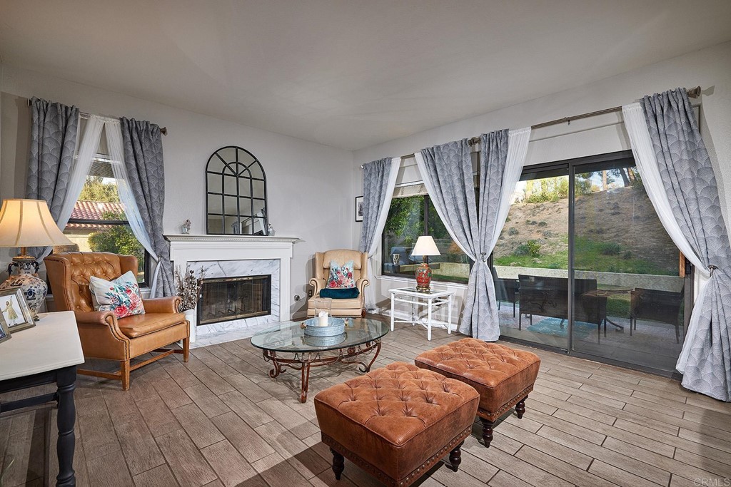 3518 Sarah Ann Drive Fallbrook, CA 92028 - Photo 12 of 49 a living room with furniture a fireplace and a floor to ceiling window
