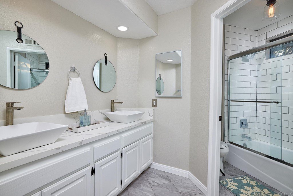 3518 Sarah Ann Drive Fallbrook, CA 92028 - Photo 31 of 49 a bathroom with a double vanity sink and a mirror
