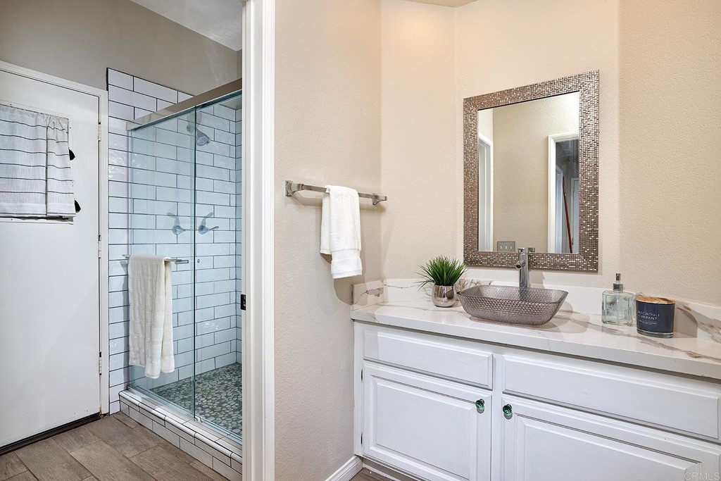 3518 Sarah Ann Drive Fallbrook, CA 92028 - Photo 33 of 49 a bathroom with a granite countertop sink and a mirror