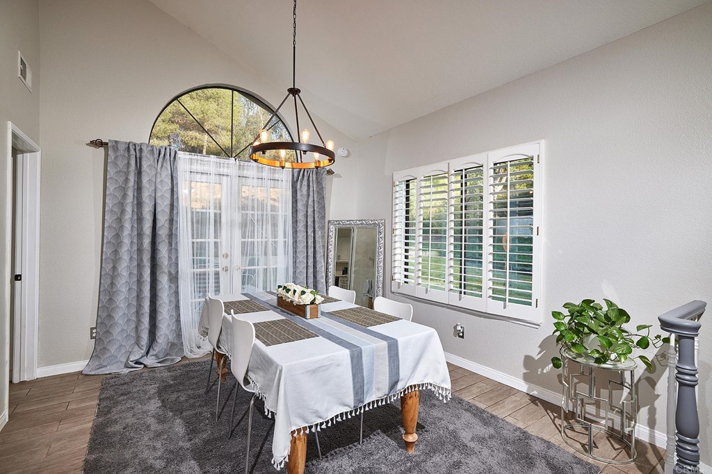 3518 Sarah Ann Drive Fallbrook, CA 92028 - Photo 6 of 49 a spacious bedroom with a bed and a chandelier