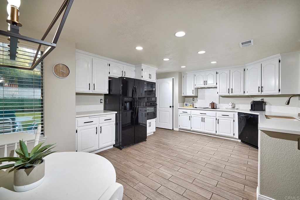 3518 Sarah Ann Drive Fallbrook, CA 92028 - Photo 7 of 49 a kitchen with refrigerator a sink and cabinets