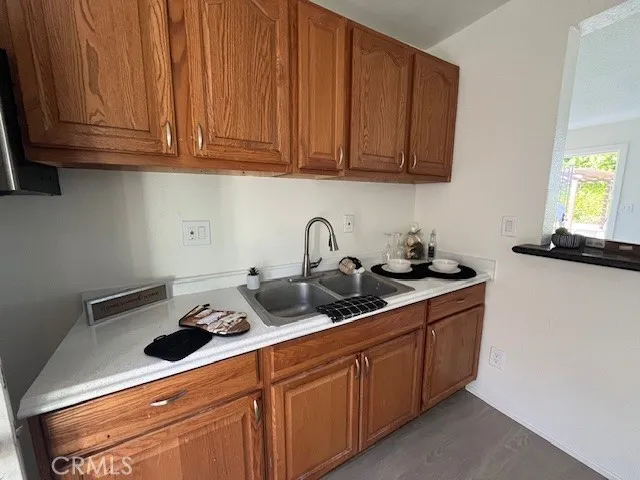 a kitchen with stainless steel appliances granite countertop a sink dishwasher stove and cabinets with wooden floor
